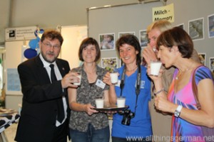 Volker Bouffier drinks a glass of milk at the Hessentag in Oberursel