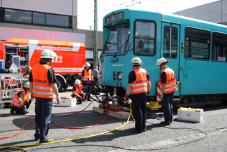 The fire brigade de-rail and then re-rail a tram. The fire brigade de-rail and then re-rail a tram.