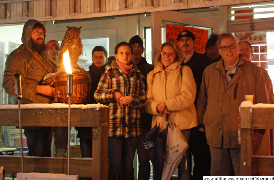 The group with torches and candles outside the kiosk.