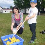 Megan Wellens explaining Hook-a-Duck to 4-year-old Valentin